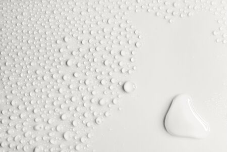 Water drops on smooth white background, close-upの写真素材