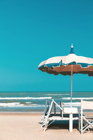 Beach in late summer, deckchairs and parasolの写真素材
