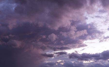 Dramatic sky with cumulus clouds at dusk, natural background