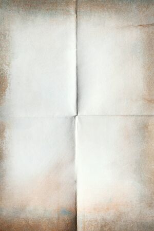 Close-up of old paper folded in four texture backgroundの写真素材