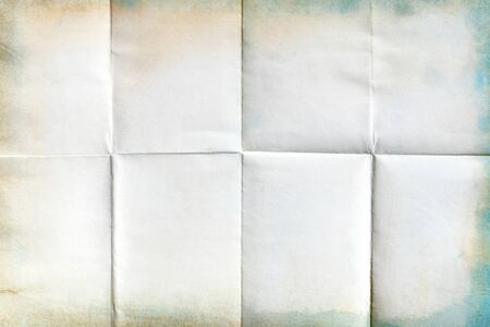 Close-up of old paper folded in eight texture backgroundの写真素材