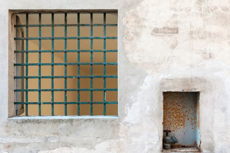 Wall part of old building, railings on window