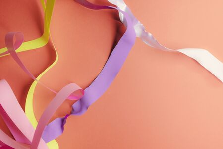 Close-up of colorful ribbons on orange backgroundの写真素材