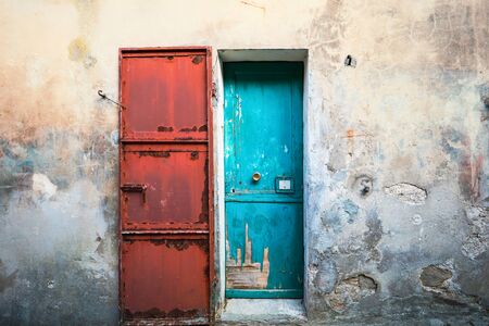 Doors blue and red, old building front view