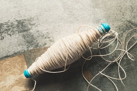 Cotton thread spool, rough surface on background