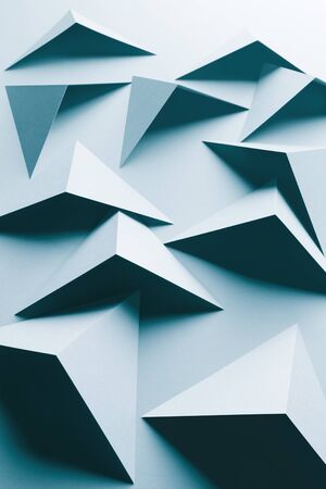 Abstract pattern made of colored paper, triangular shapes, light blue backgroundの写真素材