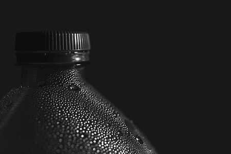Close-up of plastic bottle, mineral water, black backgroundの写真素材