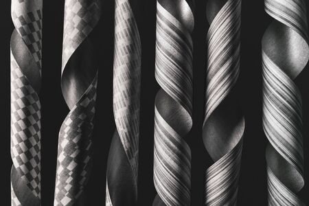 Twisted paper decorative elements on black background, abstractの写真素材