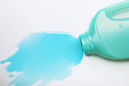 Blue liquid detergent spilled on the table, isolated on whiteの写真素材