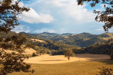 Rural landscape in spring, hills and blue sky with cloudsの写真素材