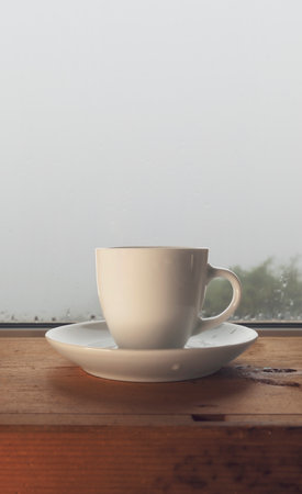 Winter day morning, cup of coffee on the old tableの写真素材