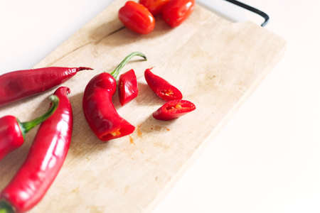 Preparing lunch, ingredients on wooden cutting board, hot red peppersの写真素材