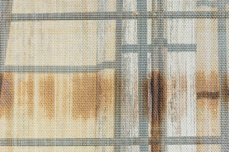 Close-up of window with iron mesh, texture backgroundの写真素材