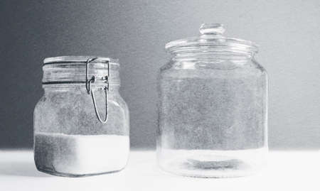Two glass jars, black and white texture backgroundの写真素材