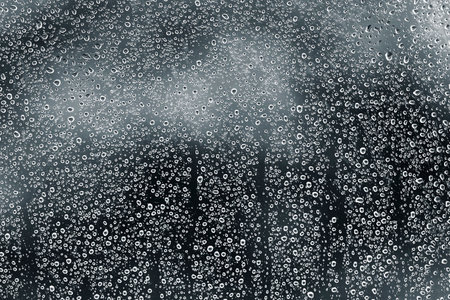 Water drops in the window glass, by nightの写真素材