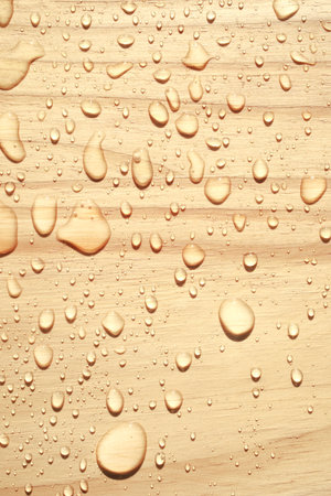 Close-up of fresh water drops on wooden surface