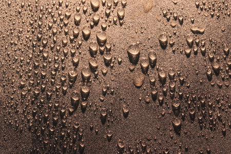 Macro of Water drops on rough surface, bronze toneの写真素材