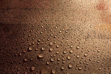 Macro of Water drops on rough surface, bronze toneの写真素材