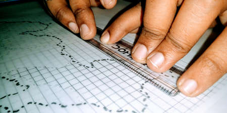 Indian college student doing homework at home