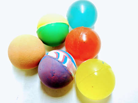 A picture of multi color rubber balls on white background