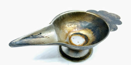 A picture of old and rusted lamp on white background