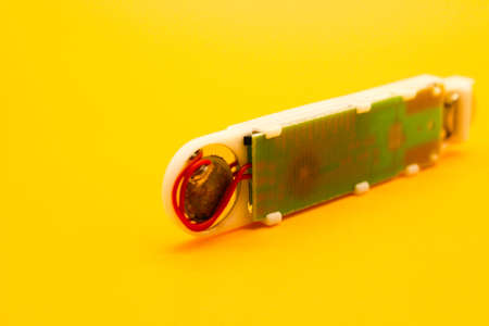 Digital thermometer isolated on yellow background with selective focusの写真素材
