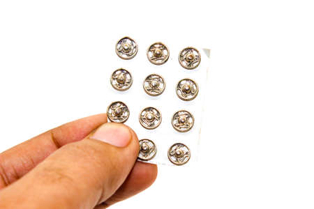 Steel buttons on white background with selective focus