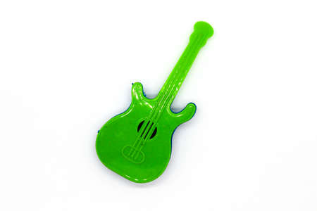 Toy guitar on white background with selective focusの写真素材