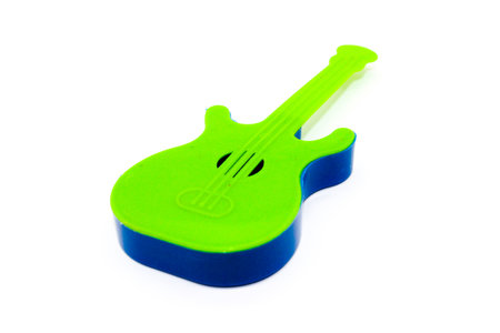 Toy guitar on white background with selective focusの写真素材