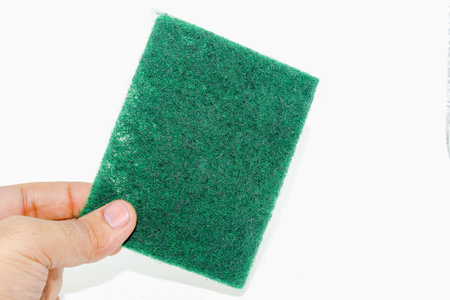 Green hand scrubber with fine fibers isolated on white backgroundの写真素材