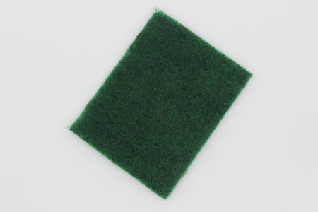 Green hand scrubber with fine fibers isolated on white backgroundの写真素材