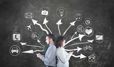 Teenagers and modern technology concept with an drawn arrows  and icons on chalkboard