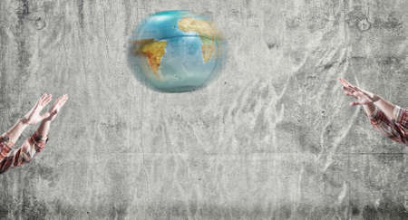 Teenager playing voleyball with earth globe