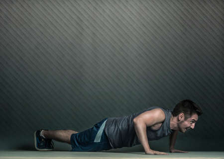 Athlete male in sportswear doing push upsの写真素材