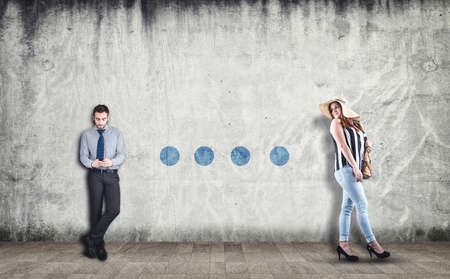 Beautiful women walking and looking behind to a businessman using a phone, drawing dots on wall. The concept of communicationの写真素材