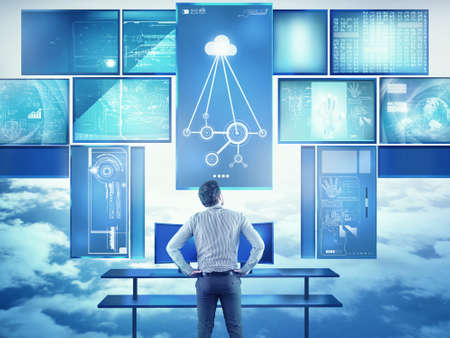 Young businessman works with multi screens in the office, modern technology conceptの写真素材