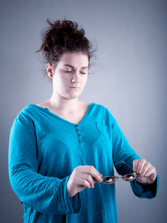 Young woman takes down her eyeglasses including her eyes.