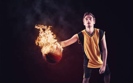 Basketball player dribbling with a burning ball.の写真素材