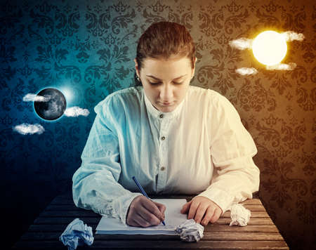 Young woman stay at the desk and writing , has sun and moon floating on either side of her head. Concept of working day and night.の写真素材