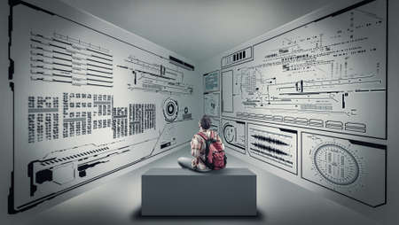 Teenager sitting on a box and studying the information wrriten on walls.の写真素材