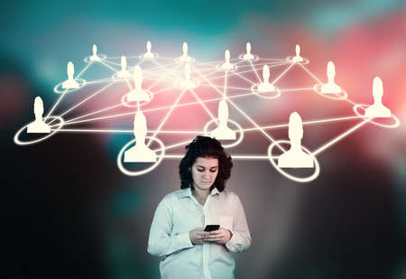 Woman using smartphone in front of a people network sketch.