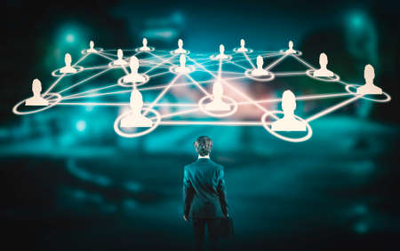 Young businessman in front of network of people.