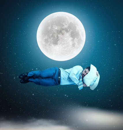Man floating in space while sleeping.の写真素材
