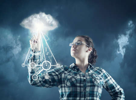 The young woman pressing touch screen on social network icon, cloud connectionsの写真素材