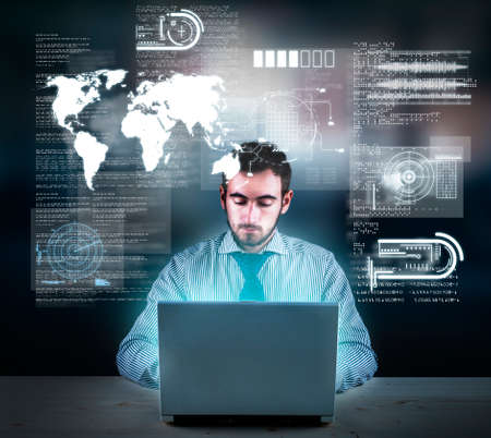 Businessman working on laptop with a futuristic infograph interface in front of him