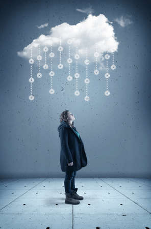 Young woman looks up to a cloud . The concept of cloud storage.の写真素材