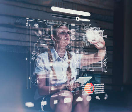 Young woman using tablet and infograph screen at home.Futuristic user interface.の写真素材