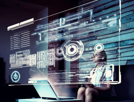 Young woman using tablet and infograph screen at home.Futuristic user interface.