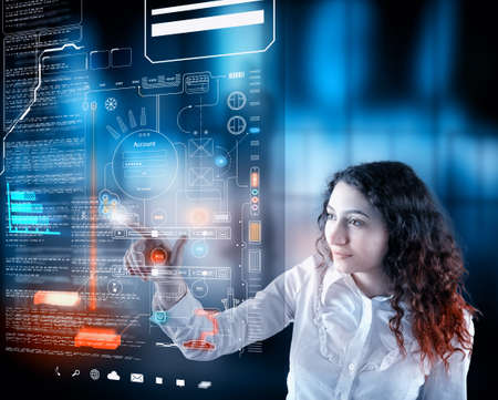 Woman working on digital touch screen with data and informations.Futuristic user interface.