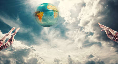 Playing voleyball with earth globe.の写真素材